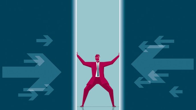 Business man in suit pushing against walls closing in