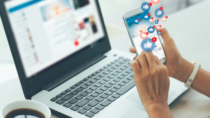 Using social media on phone and laptop