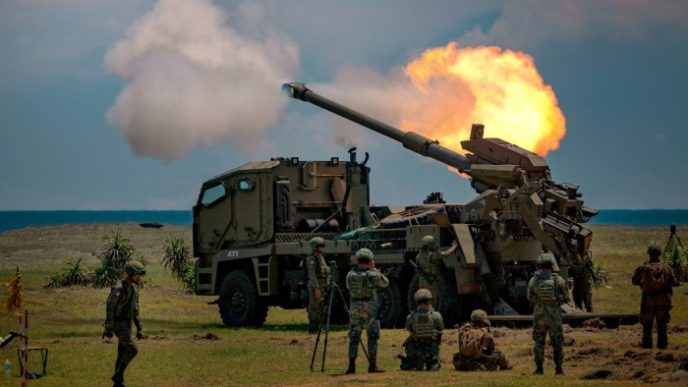 Philippine troops fire a howitzer during an exercise