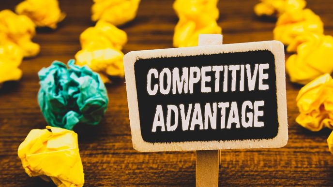 Sign on table saying Competitive Advantage with scrunched up paper balls