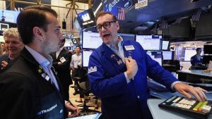 Wall St rises on jobs data optimism, Tesla