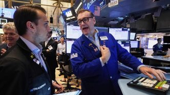 Wall St rises on jobs data optimism, Tesla
