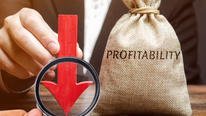 Hand holds down arrow on profitability