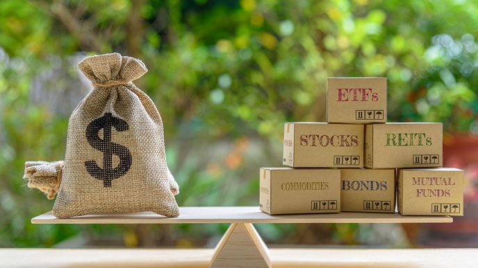 Scale with bag of money on one side and different securities on the other