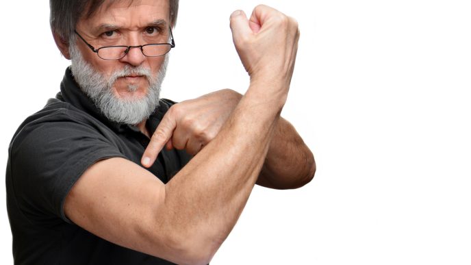 Old man pointing to muscle